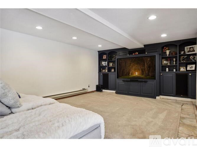 A bedroom with a large bed and a television in the corner.