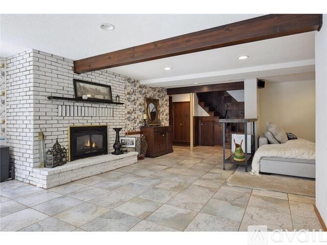 A living room with a fireplace and a bed.