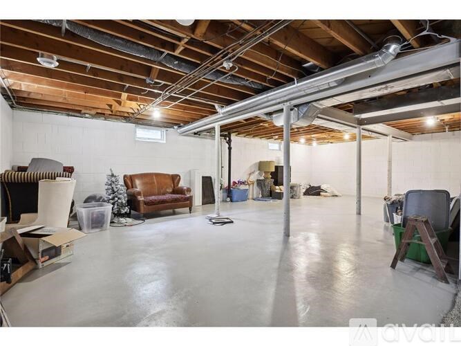 A spacious garage with a concrete floor and a high ceiling.