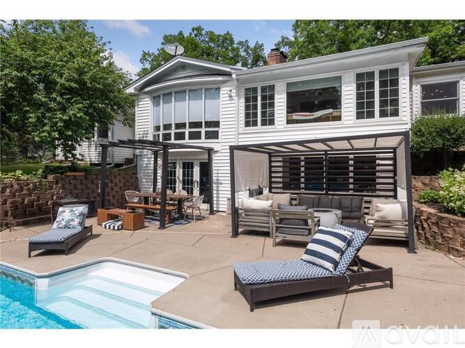 A house with a pool and a sun lounger.