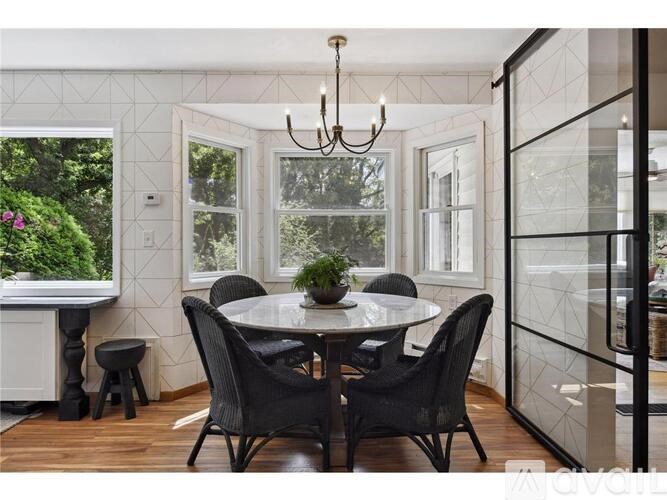 A dining room with a round table and chairs.