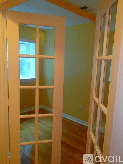 A room with a white door and a window.