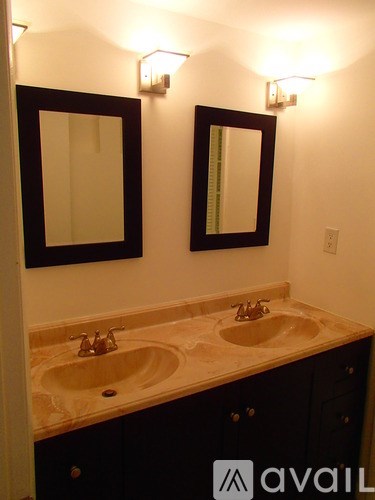 A bathroom with two sinks and two mirrors.