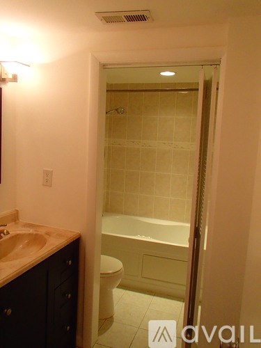 A bathroom with a sink, toilet and bathtub.