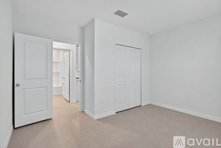 A white door is open to a hallway.