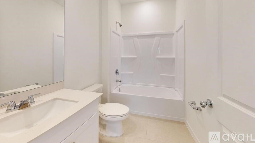 A spacious room with a window and carpeted floor.