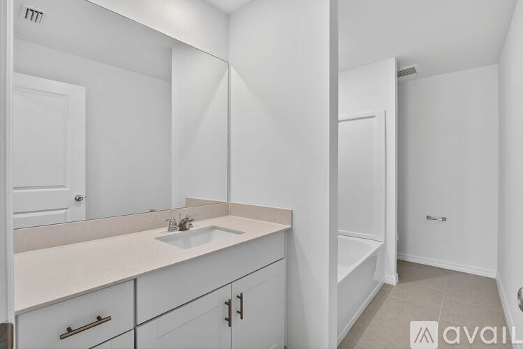 A bathroom with a sink, mirror, and cabinets.