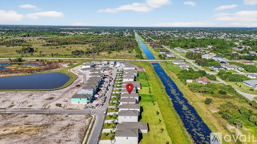 A bird's eye view of a residential area with a river running through it.