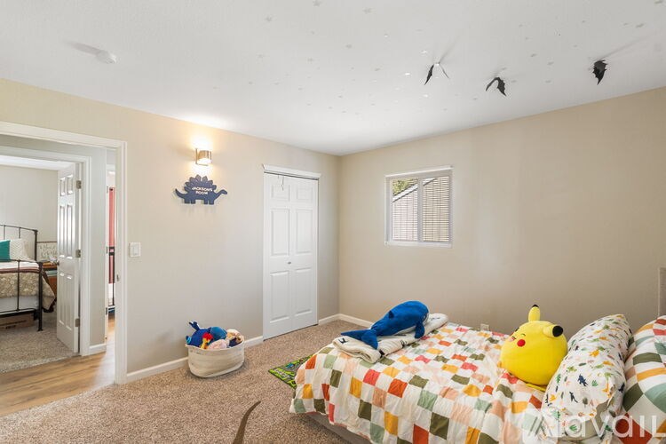 A bedroom with a bed and a window.