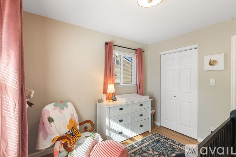A baby's room with a white crib and a teddy bear.