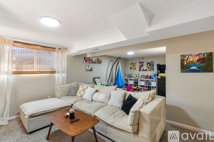 A living room with a white couch and a coffee table.