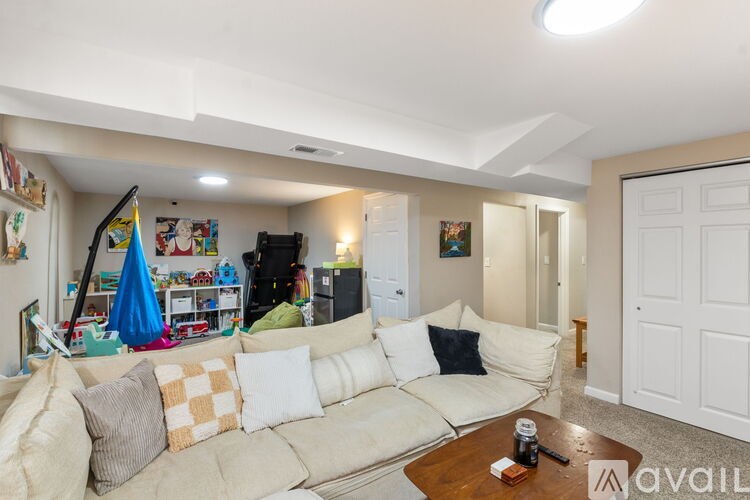 A living room with a white couch and a coffee table.