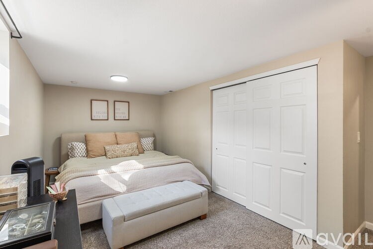 A bedroom with a large bed and a white door.