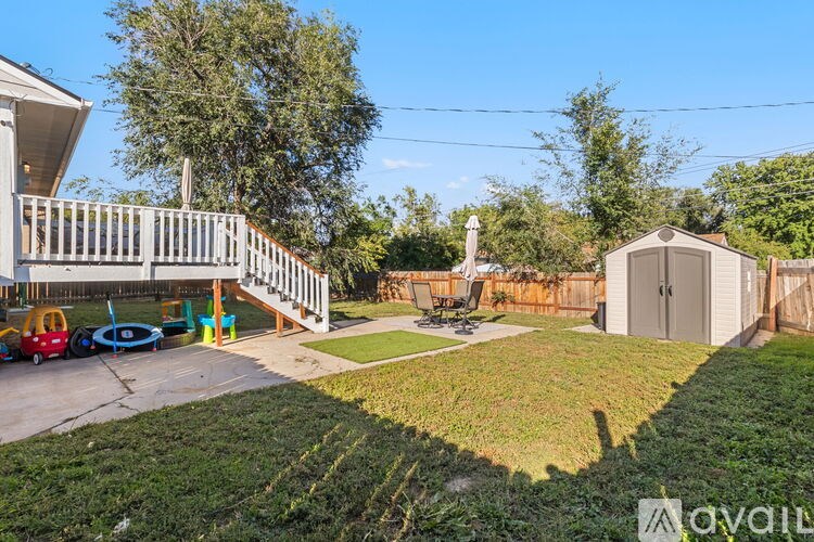 A backyard with a playground and a shed.