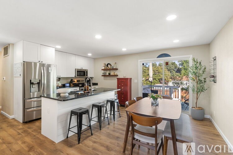 A kitchen with a bar and a dining table.