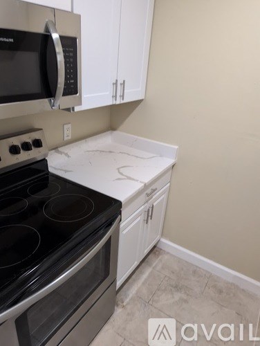 A kitchen with a stove top oven and microwave.