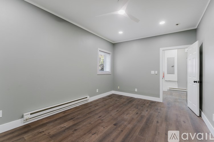 A room with a wooden floor and a white door.