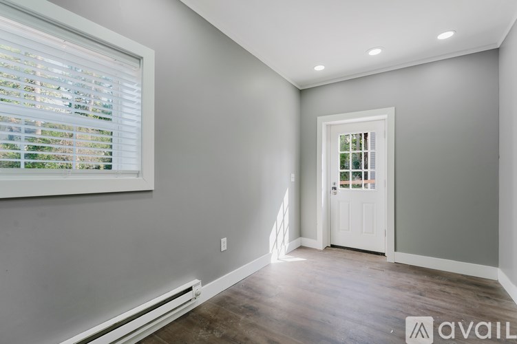 A room with a window and a door.