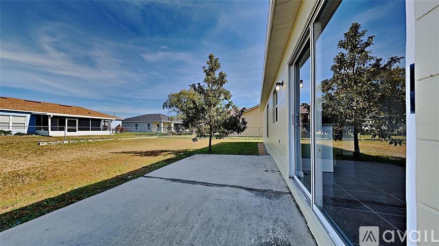 A house with a driveway and a tree in front of it.