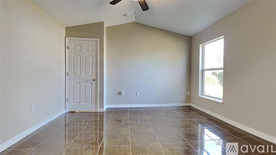 A room with a tiled floor and a ceiling fan.