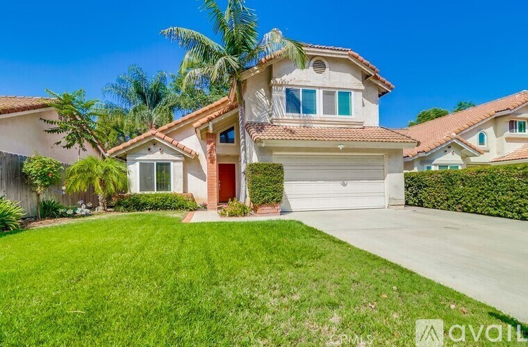 A house with a red door is for sale.
