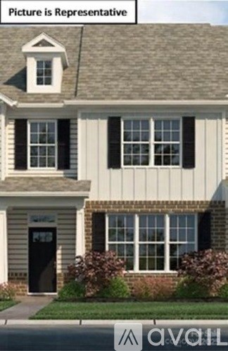 A house with a grey roof and a black door.