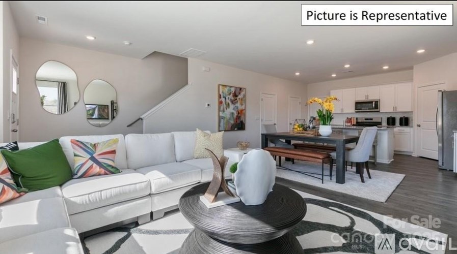 A modern living room with a white sofa and a coffee table.