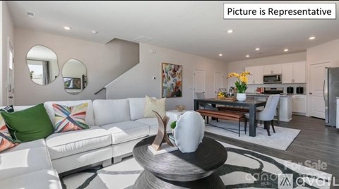 A modern living room with a white sofa and a coffee table.