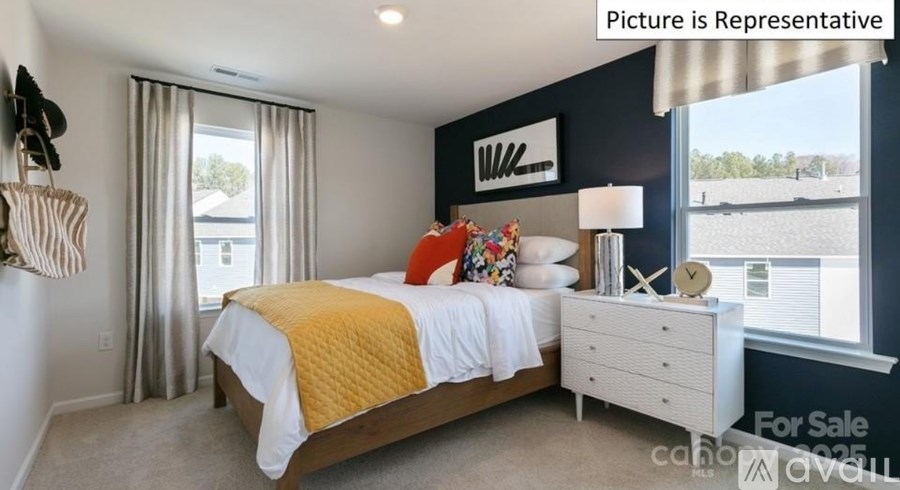 A bedroom with a bed, nightstand, and window with a view.