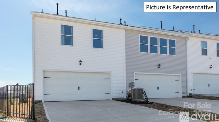 A two-story house with a garage is for sale.