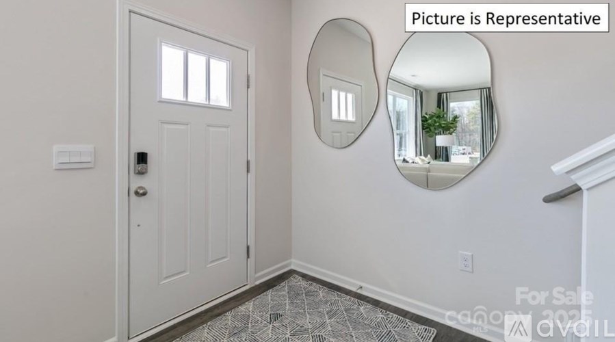 A white door with a round mirror above it and a tiled floor.