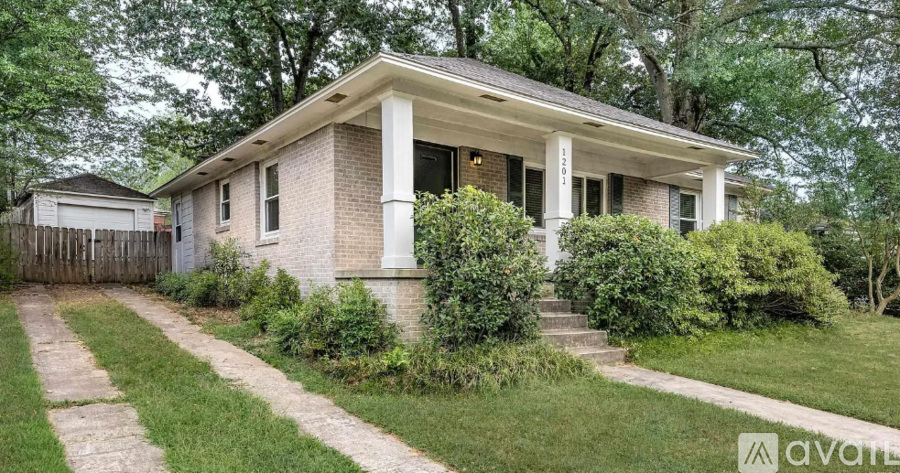A house with a front yard and a driveway.