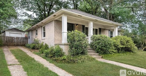 A house with a front yard and a driveway.