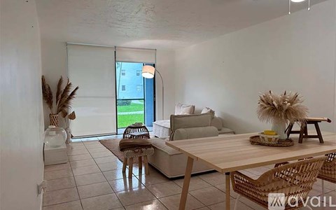 A living room with a wooden table and chairs.