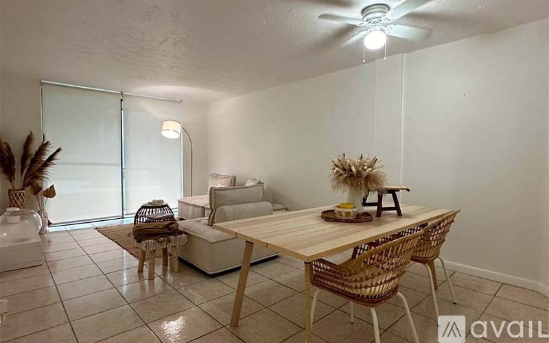 A dining area with a wooden table and chairs.