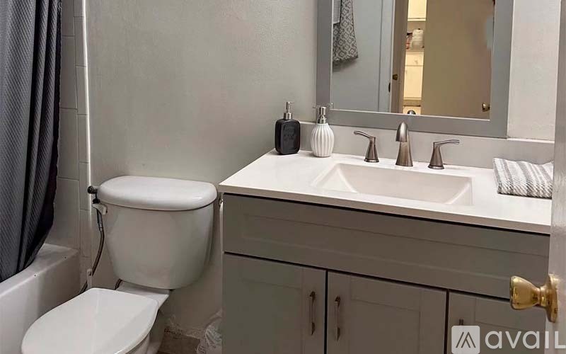 A white toilet sits next to a sink in a bathroom.