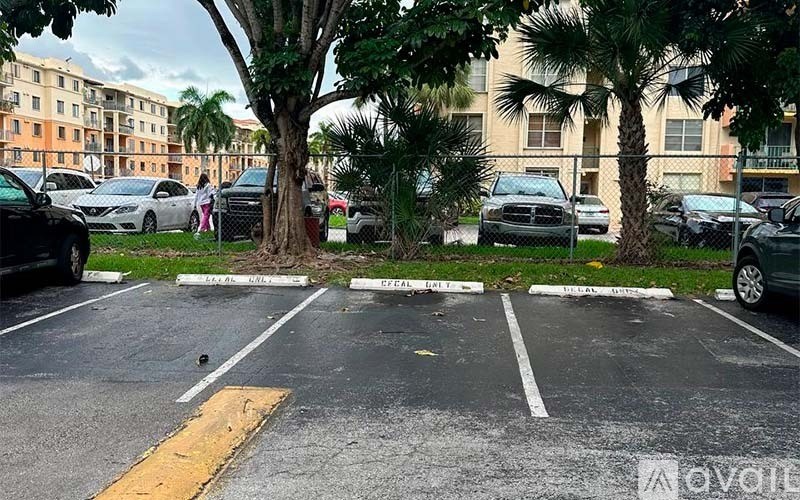 A parking lot with cars parked and a yellow line in the middle.