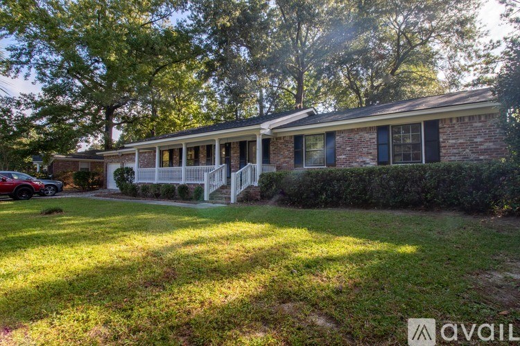 A house with a red car parked in front.
