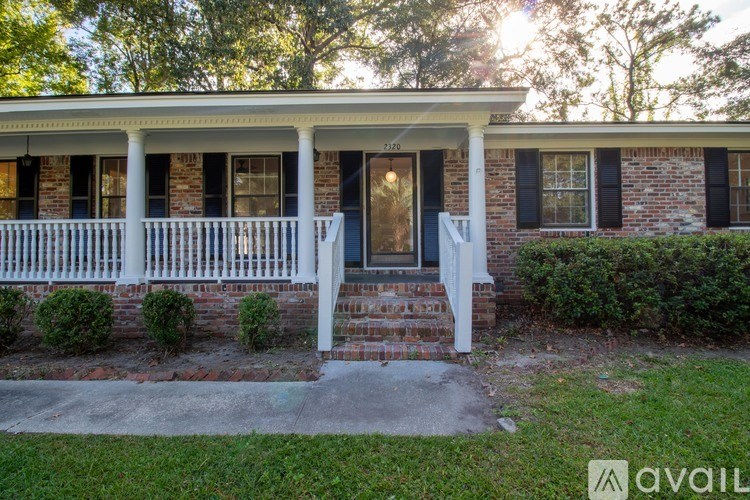 A house with a blue door and white porch.