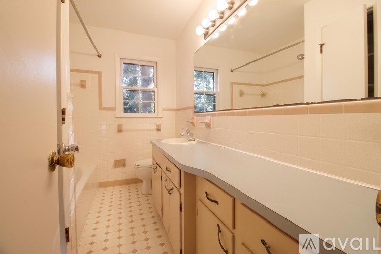 A bathroom with a white sink and a tiled floor.