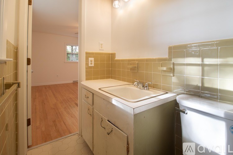 A bathroom with a sink, toilet, and bathtub.