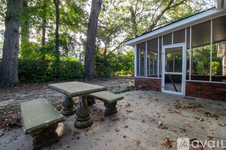 A table and two chairs are set up outside a house.