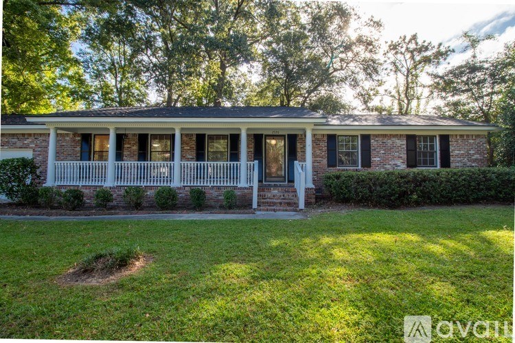 A house with a front porch and a white picket fence.