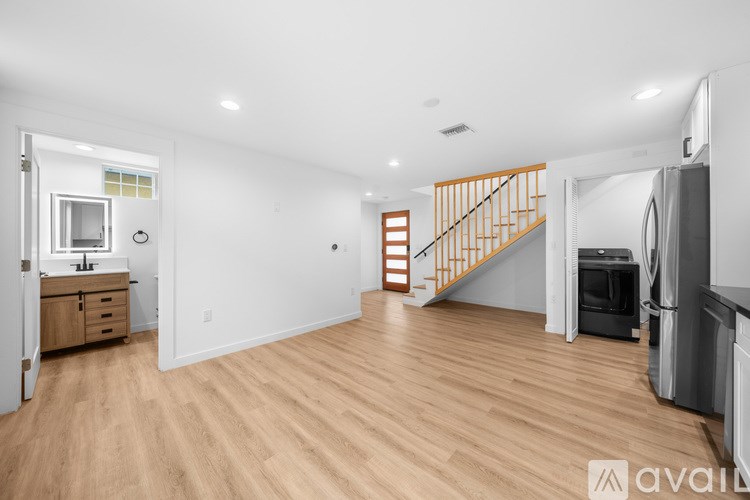 A spacious living area with a staircase leading to the upper floor.