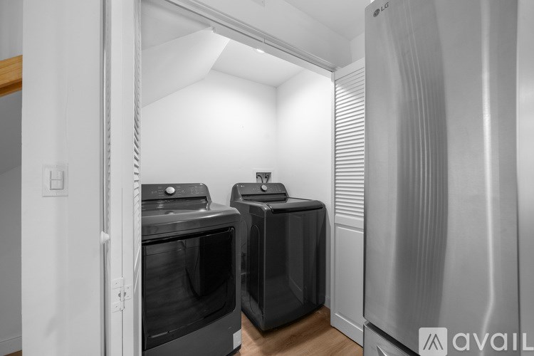 A modern kitchen with a black oven and a silver fridge.