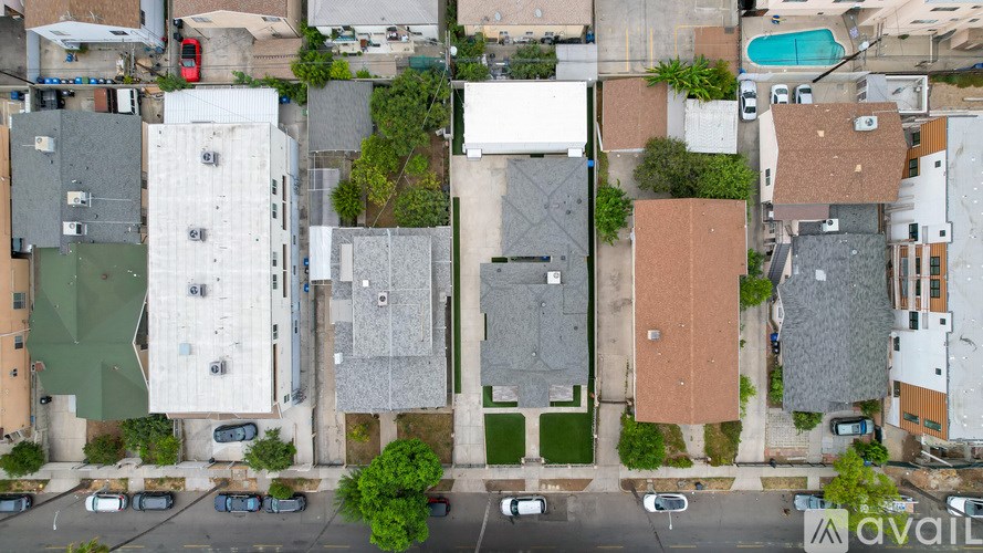 A bird's eye view of a residential area with houses and cars.
