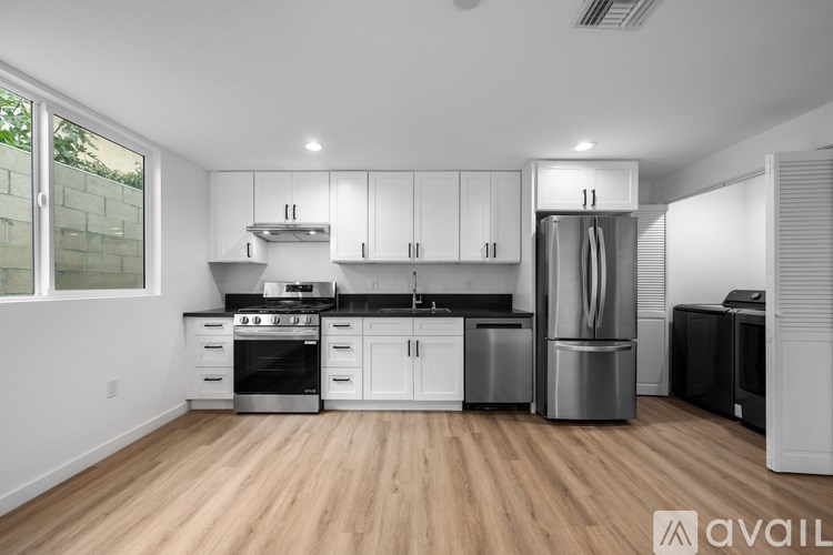A kitchen with white cabinets and stainless steel appliances.
