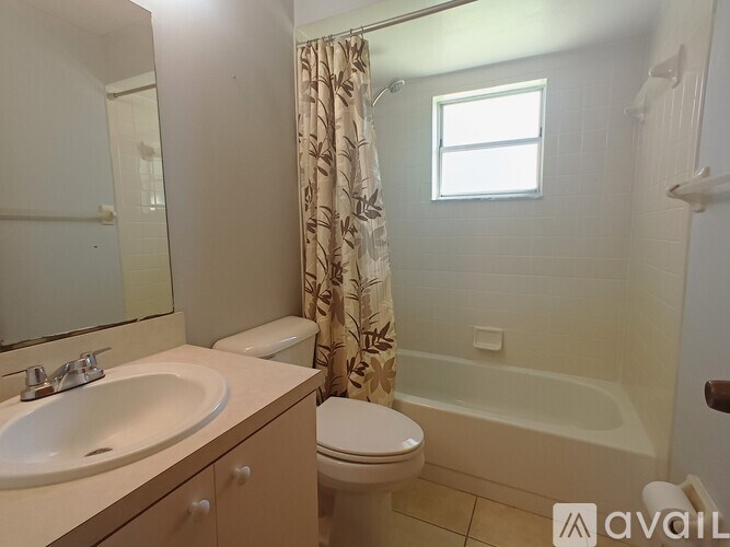 A bathroom with a sink, toilet, and bathtub.