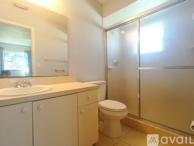 A bathroom with a sink, toilet, and shower.
