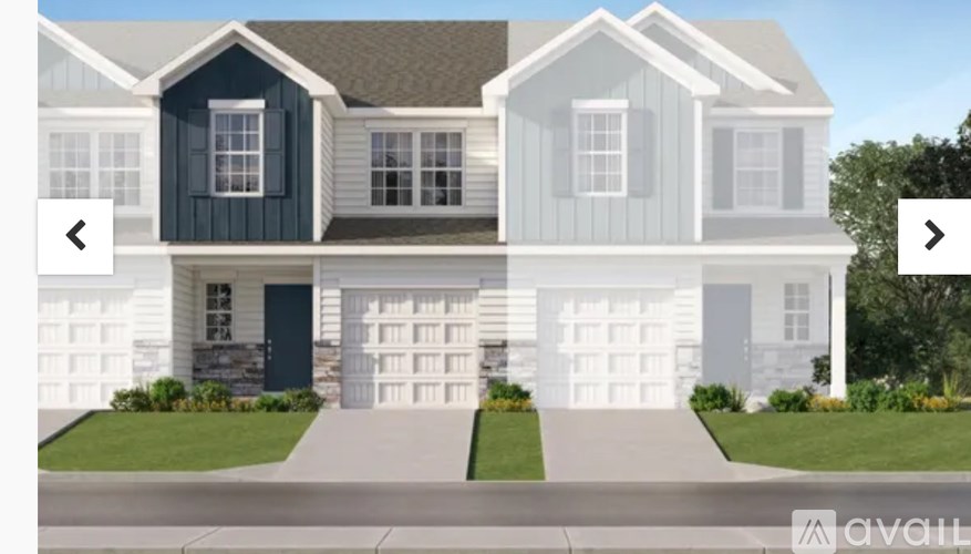 A modern two-story house with a black front door and white siding.